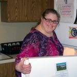 Woman posing with open refrigerator