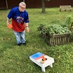 IVI client playing cornhole or bags game