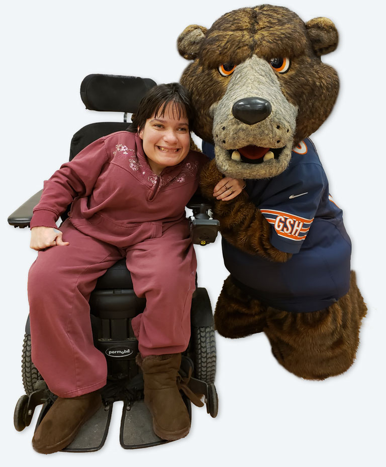 Smiling woman posing with Bears mascot